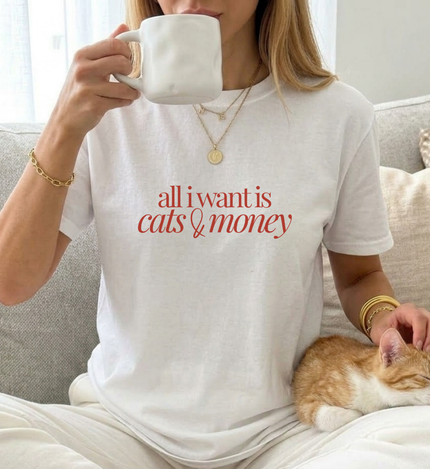 young woman is wearing a cute cat shirt with the quote all i want is cats and money in minimal typography old money style