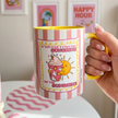 hand holding a affirmation mug 90s style