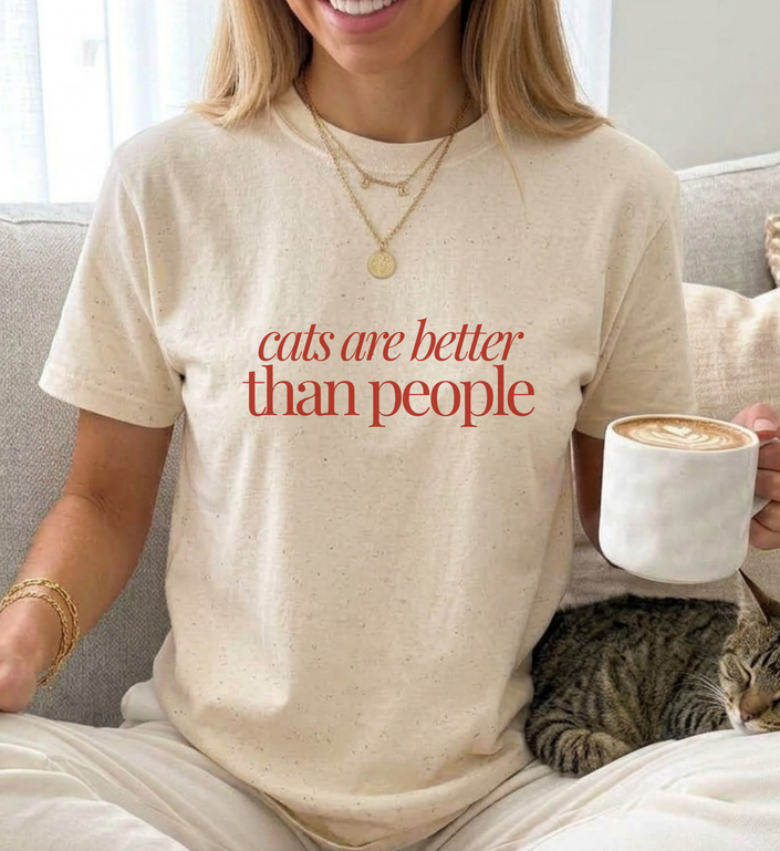young woman is wearing a cute cat shirt with the quote cats are better than people in minimal typography old money style