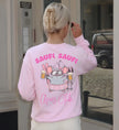 Rückansicht eines hellrosa Sweatshirts mit einer gezeichneten Maus im Tutu, die zwei Bierkrüge hält, mit dem Schriftzug Saufi Saufi Après Club.