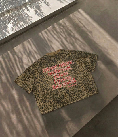 Close up view of the spicy political protest quote fuck me like the government on a sexy leopard pattern boxy shirt by Cincerely Yours.