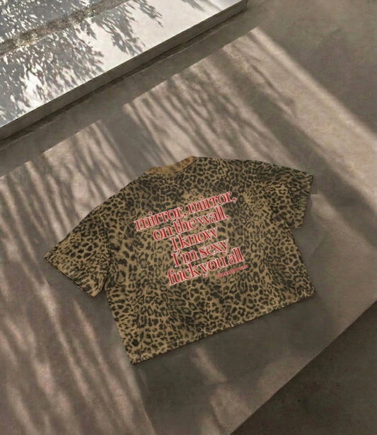 Close up view of the spicy political protest quote fuck me like the government on a sexy leopard pattern boxy shirt by Cincerely Yours.