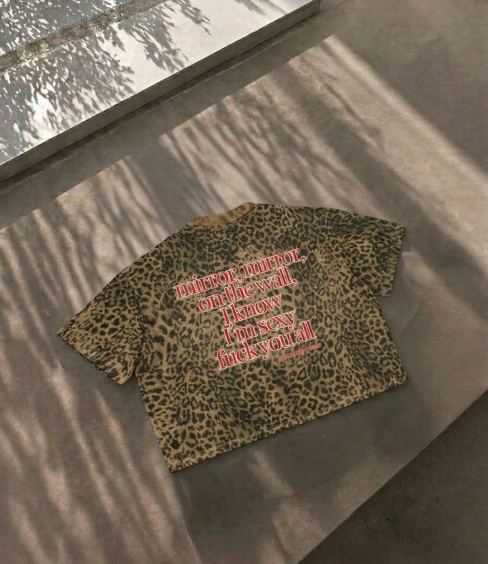 Close up view of the spicy political protest quote fuck me like the government on a sexy leopard pattern boxy shirt by Cincerely Yours.