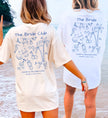 Weißes personalisiertes JGA Shirt von Cincerely Yours im handgezeichneten Doodle-Stil mit Last Toast on the Coast Motiv für die Braut am Strand.