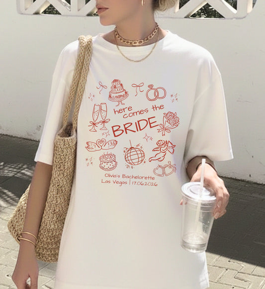 Weißes Oversized T-Shirt für die Braut mit handgezeichnetem roten Doodle-Print, ideal für den Junggesellinnenabschied (JGA) mit Motiven wie Hochzeitstorte, Ringen und Champagner.